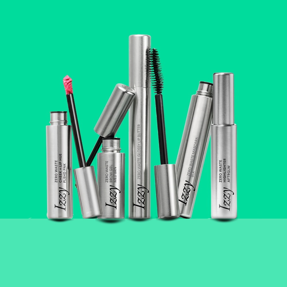 Set of Izzy makeup products including mascara and eyeliner on a green background