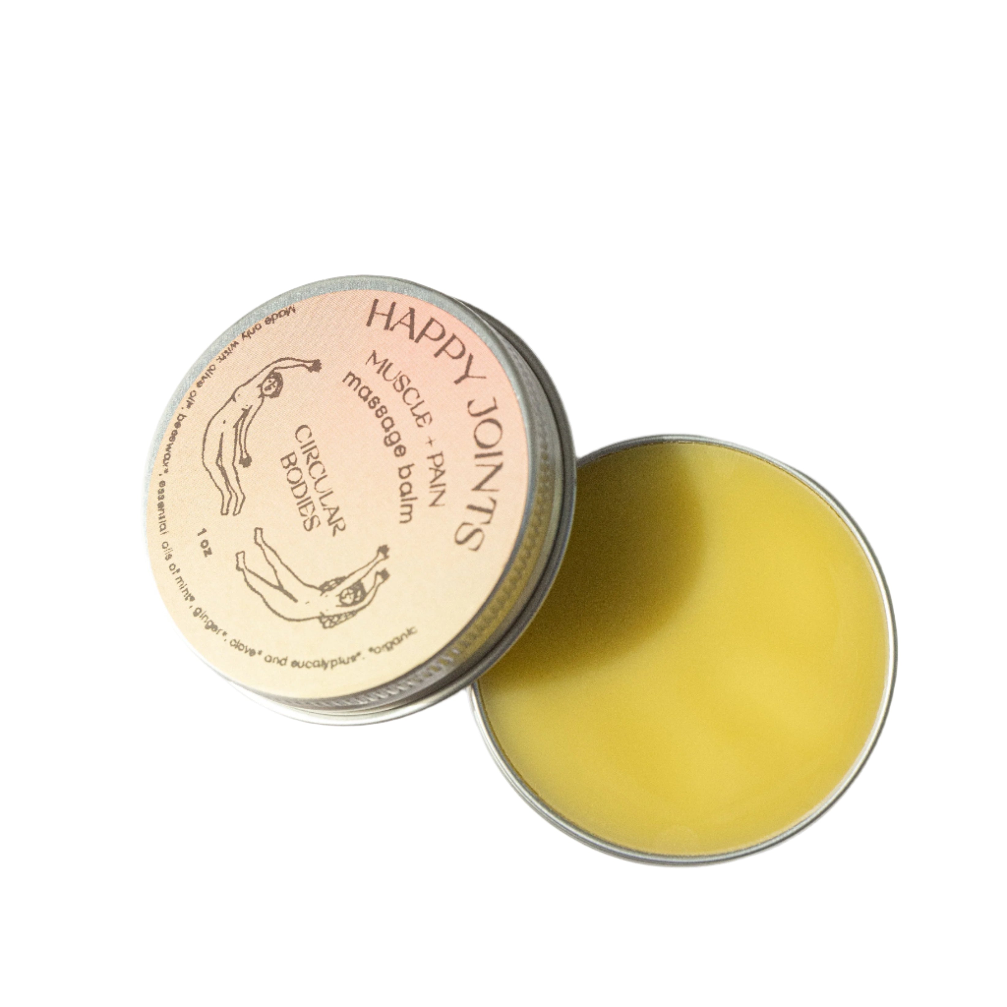 Open tin of Happy Joints massage balm with a ginger root and eucalyptus leaves on a light background
